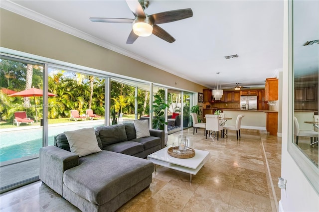 living area with crown molding, a ceiling fan, and visible vents