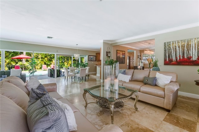 living area with baseboards, an inviting chandelier, ornamental molding, and a wealth of natural light