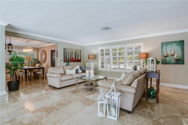 living room featuring crown molding, a notable chandelier, visible vents, and baseboards