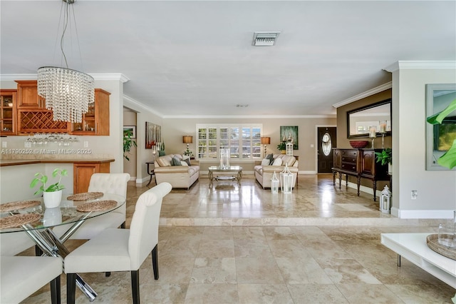 living area featuring a chandelier, baseboards, visible vents, and ornamental molding