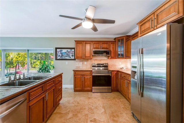kitchen featuring a sink, ornamental molding, stainless steel appliances, and brown cabinets