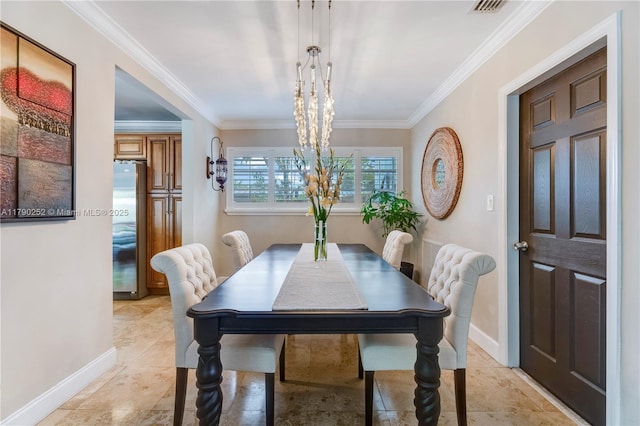 dining room featuring crown molding, light tile patterned flooring, baseboards, and an inviting chandelier