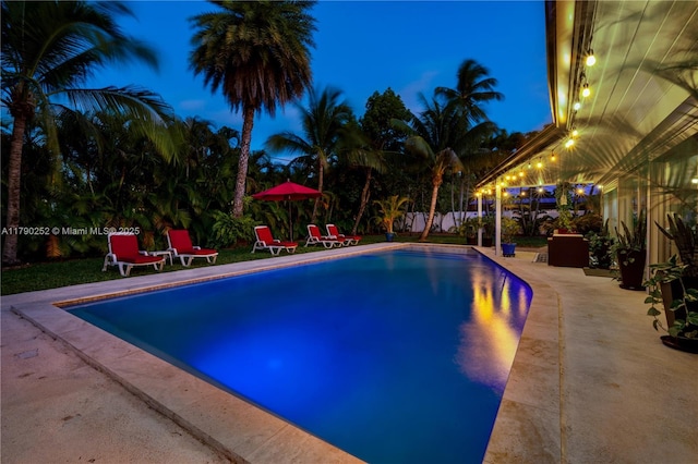 outdoor pool with a patio area
