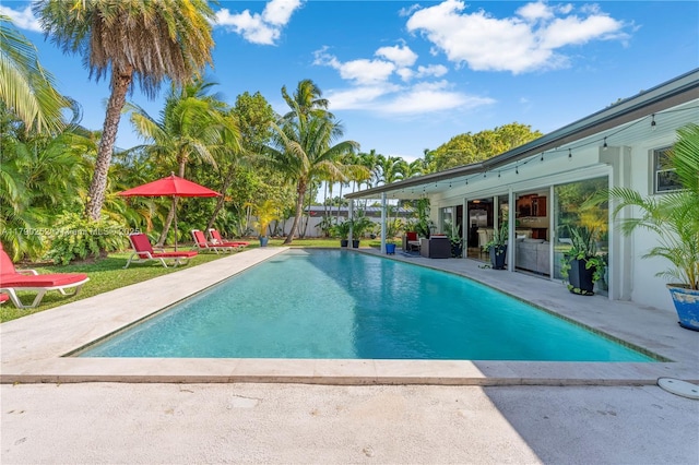 view of swimming pool with a fenced in pool and a patio area
