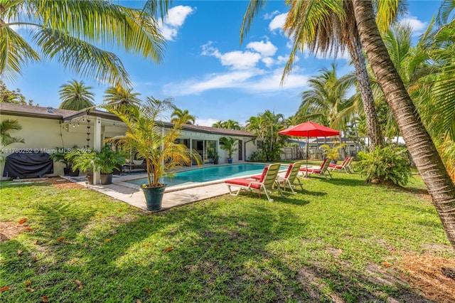 outdoor pool featuring a yard, a patio, and fence