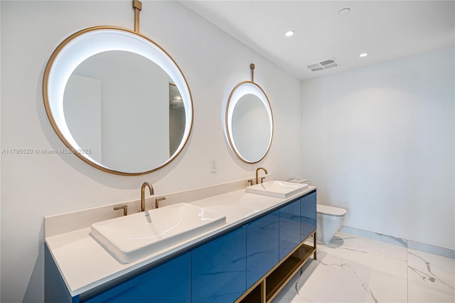 bathroom featuring a sink, recessed lighting, double vanity, and visible vents