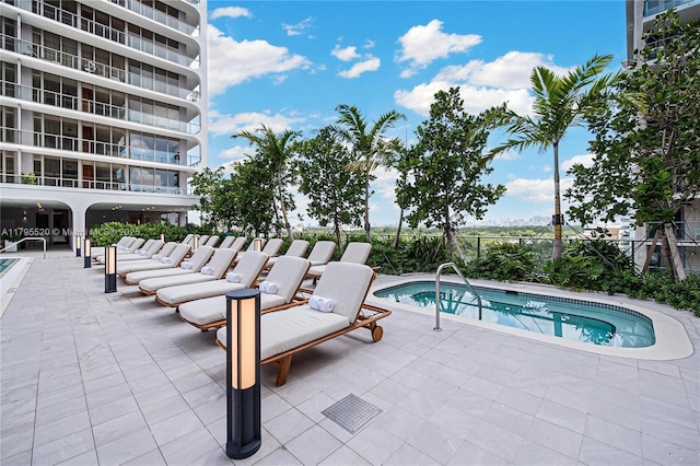 view of pool featuring fence and a patio area