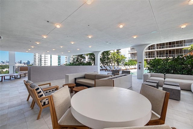 dining space featuring a view of city and light tile patterned floors