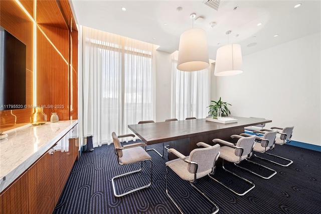 dining room with dark carpet and visible vents