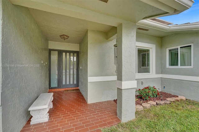 property entrance with stucco siding