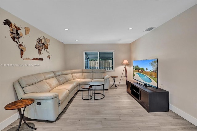 living area with recessed lighting, light wood finished floors, and visible vents