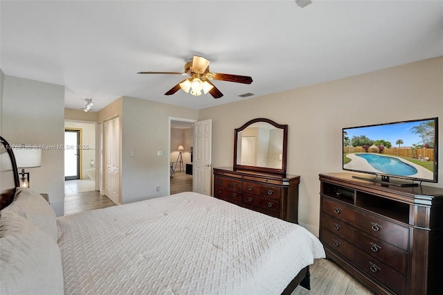 bedroom with ceiling fan, a closet, light wood finished floors, and visible vents