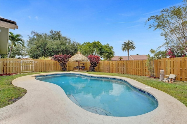 view of swimming pool featuring a yard, a fenced in pool, and a fenced backyard