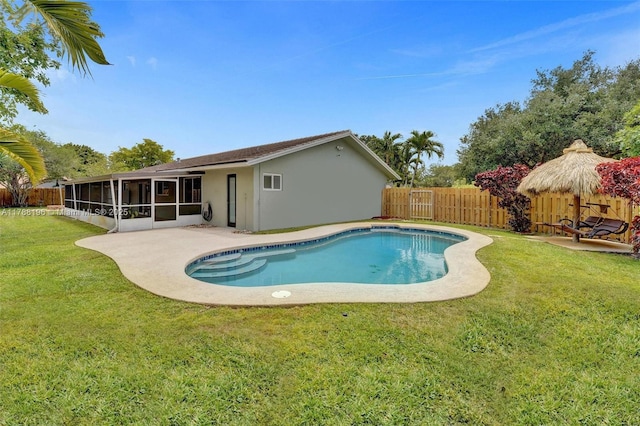 view of pool featuring a sunroom, a fenced backyard, a lawn, and a fenced in pool