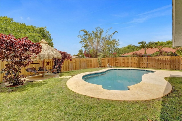view of pool featuring a yard, a patio, and a fenced backyard