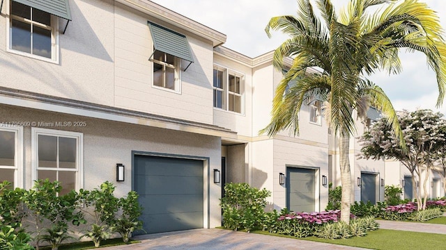 view of front of home with a garage, stucco siding, and driveway