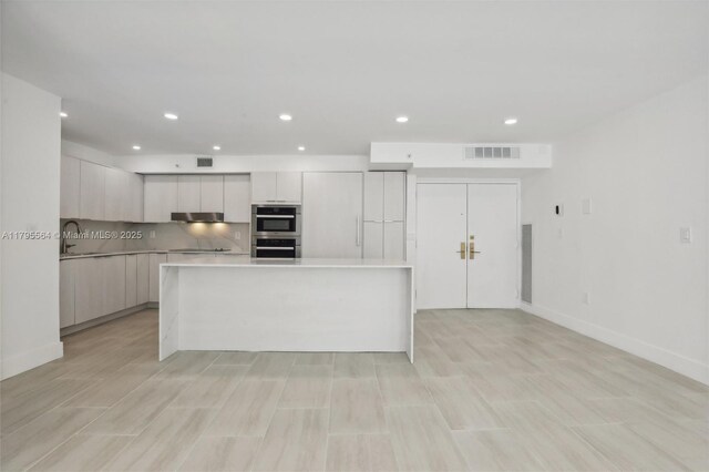 9 Island Ave Unit 1209, Miami Beach, FL 33139 - kitchen featuring stainless steel double oven, visible vents, modern cabinets, light countertops, and recessed lighting