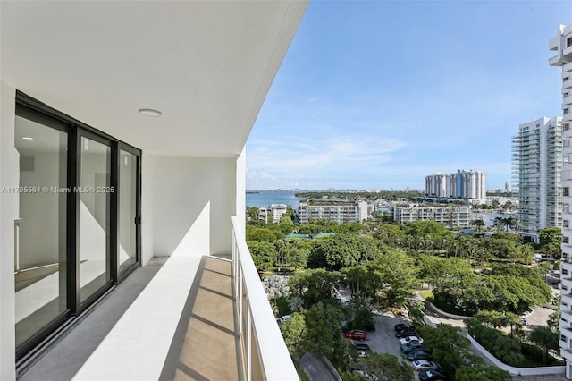 balcony with a water view and a view of city