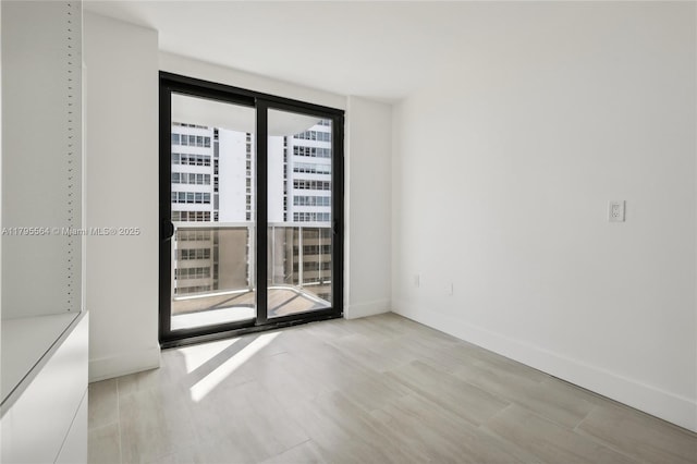 empty room featuring baseboards and wood finished floors