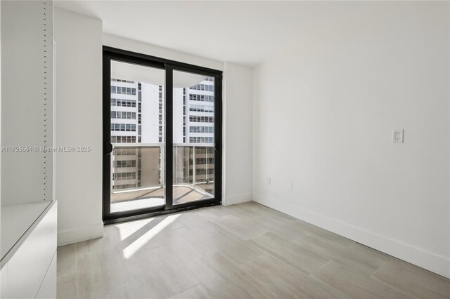 9 Island Ave Unit 1209, Miami Beach, FL 33139 - empty room featuring baseboards and wood finished floors