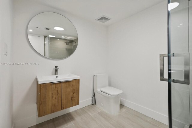 9 Island Ave Unit 1209, Miami Beach, FL 33139 - bathroom featuring baseboards, visible vents, vanity, and toilet