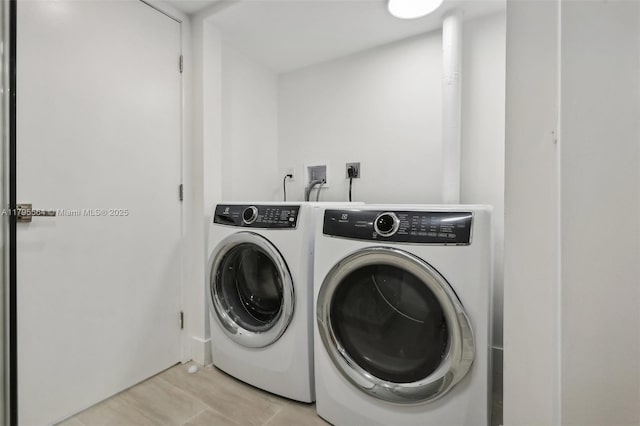 laundry room featuring washing machine and clothes dryer and laundry area