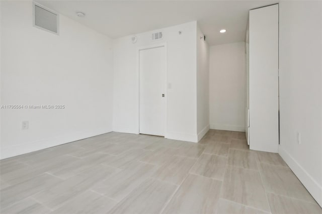 unfurnished room featuring visible vents, baseboards, and recessed lighting