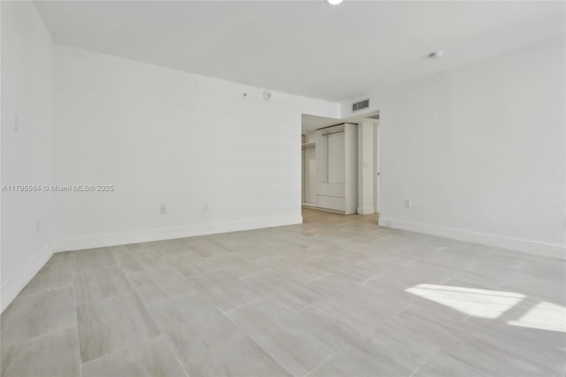 unfurnished room featuring baseboards