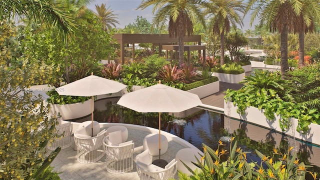 view of property's community with a water view and a patio