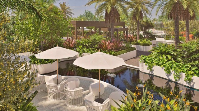 view of property's community with a water view and a patio