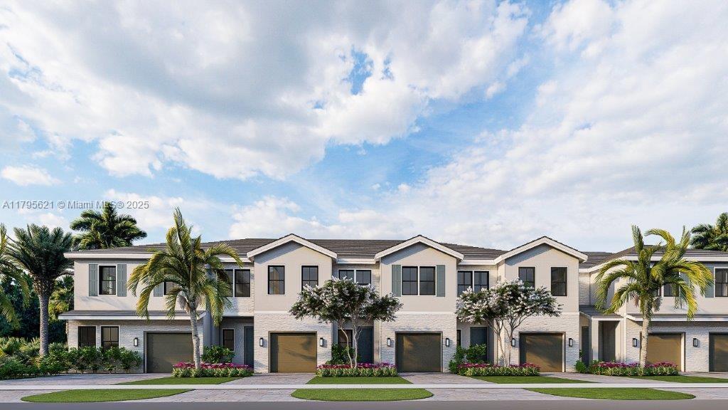 townhome / multi-family property featuring a garage, stucco siding, and driveway