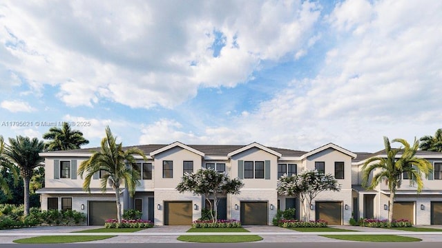 townhome / multi-family property featuring a garage, stucco siding, and driveway