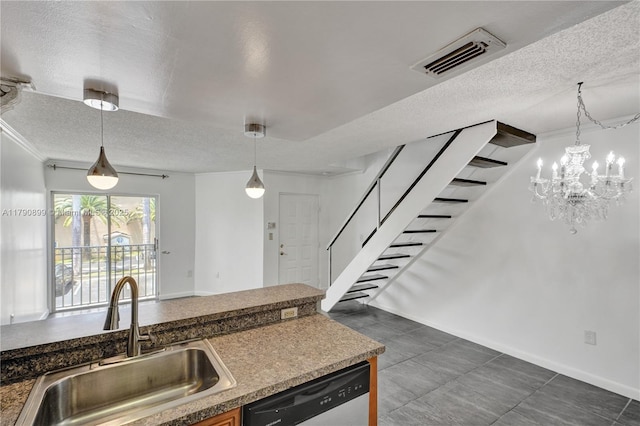 kitchen with visible vents, a sink, a textured ceiling, and stainless steel dishwasher