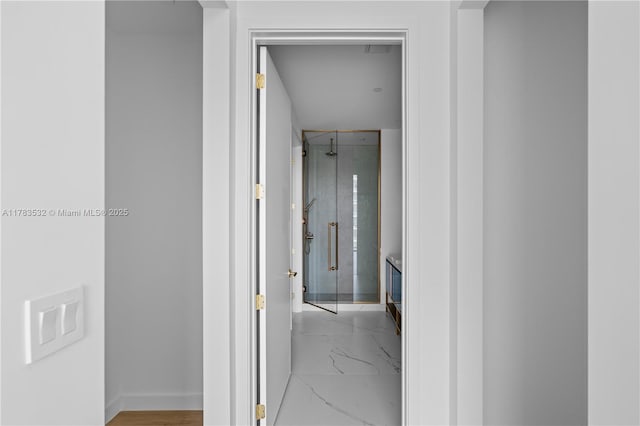 hall featuring marble finish floor