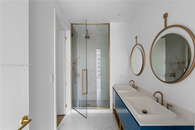 bathroom with a sink, a stall shower, double vanity, and marble finish floor