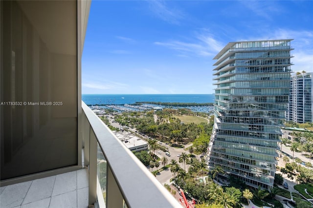 balcony featuring a city view and a water view