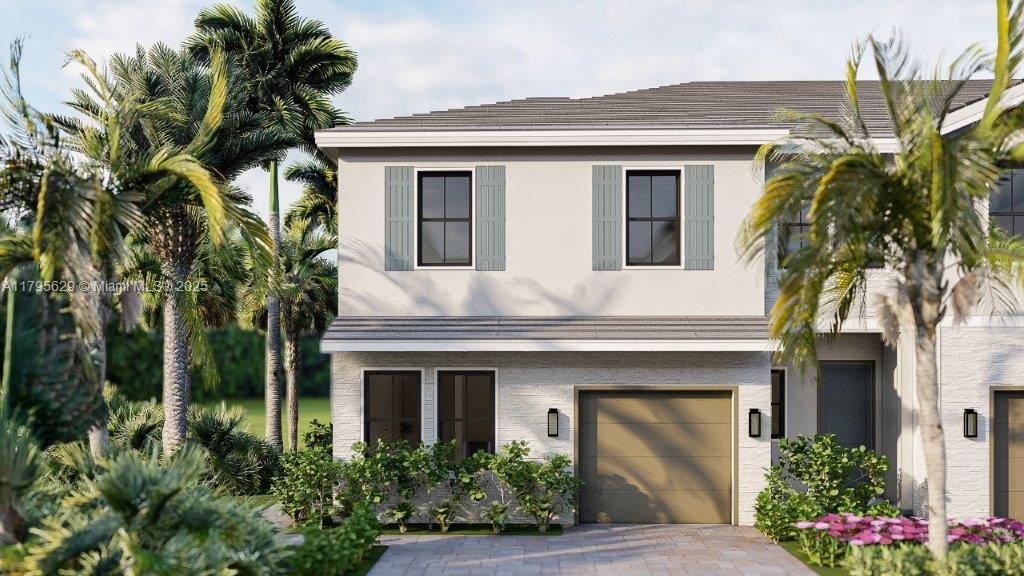 view of front of property featuring an attached garage, stucco siding, and driveway