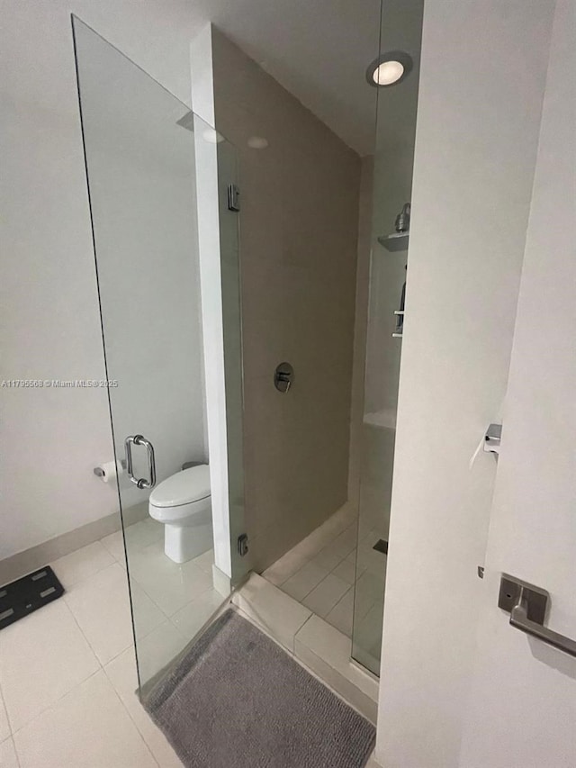 full bathroom with tile patterned flooring, toilet, and a shower stall