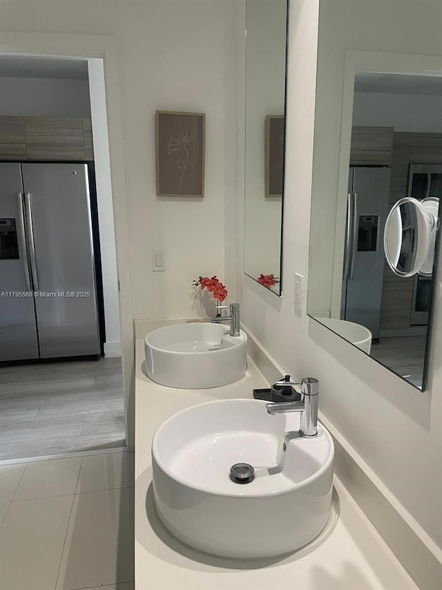 bathroom with a sink and tile patterned flooring