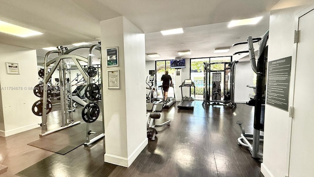 3300 NE 192nd St Unit Ph09, Aventura, FL 33180 - workout area featuring baseboards and wood finished floors