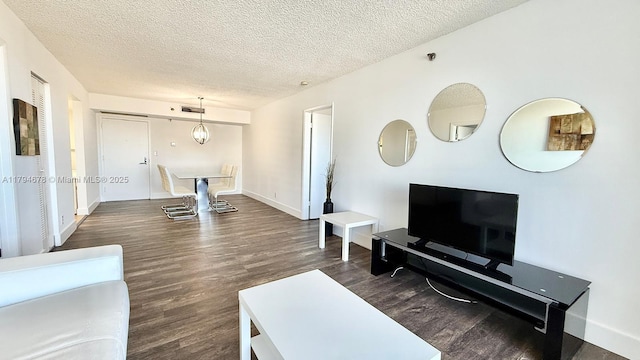 3300 NE 192nd St Unit Ph09, Aventura, FL 33180 - living room with wood finished floors, a textured ceiling, and baseboards