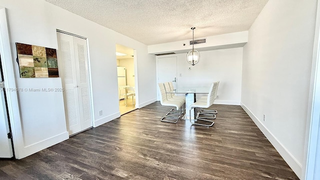 3300 NE 192nd St Unit Ph09, Aventura, FL 33180 - dining area with dark wood-style flooring, a textured ceiling, and baseboards