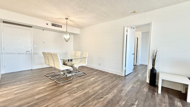 3300 NE 192nd St Unit Ph09, Aventura, FL 33180 - unfurnished dining area with wood finished floors, a textured ceiling, and baseboards