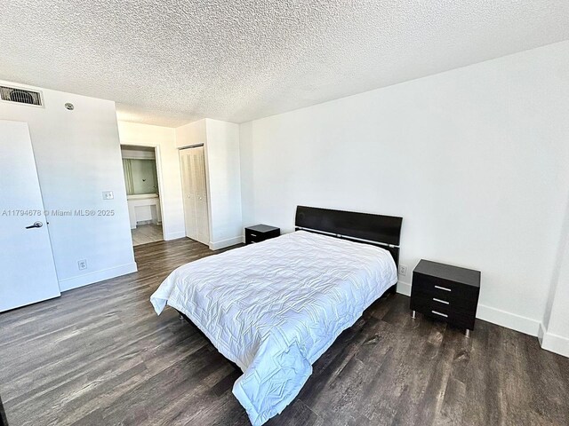 3300 NE 192nd St Unit Ph09, Aventura, FL 33180 - bedroom with wood finished floors, baseboards, a closet, and a textured ceiling