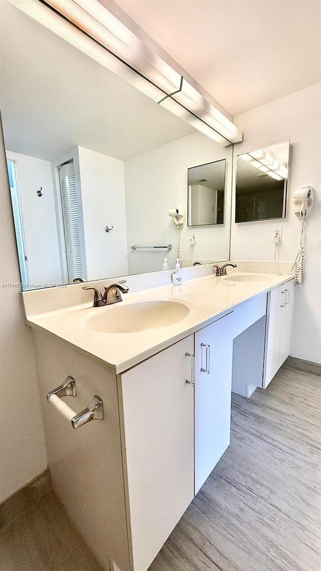 3300 NE 192nd St Unit Ph09, Aventura, FL 33180 - full bathroom featuring wood finished floors, double vanity, and baseboards