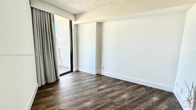 3300 NE 192nd St Unit Ph09, Aventura, FL 33180 - empty room with dark wood finished floors, baseboards, and a textured ceiling