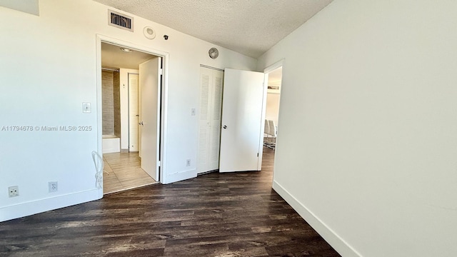 3300 NE 192nd St Unit Ph09, Aventura, FL 33180 - unfurnished bedroom featuring baseboards, a textured ceiling, wood finished floors, and a closet