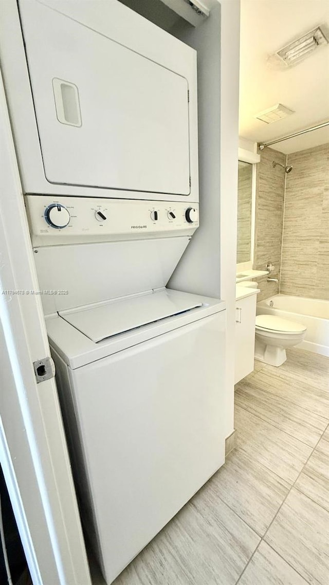3300 NE 192nd St Unit Ph09, Aventura, FL 33180 - clothes washing area with stacked washing machine and dryer