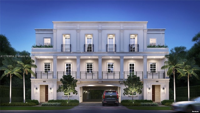 626 Malaga Ave, Coral Gables, FL 33134 - view of front facade featuring a balcony, driveway, an attached garage, and stucco siding