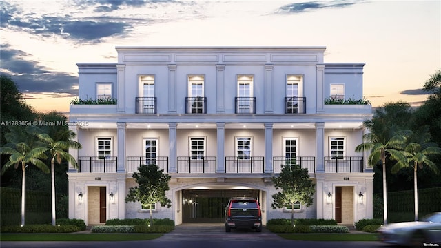 626 Malaga Ave, Coral Gables, FL 33134 - view of front facade with a balcony, driveway, and stucco siding